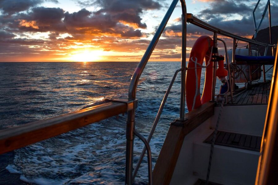 Funchal: Dolphin and Whale Watching Sunset Sailing Tour - Cabo Girão beneath the 1,903-foot cliff